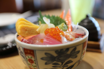 Kaisendon sushi don on rice with wood background