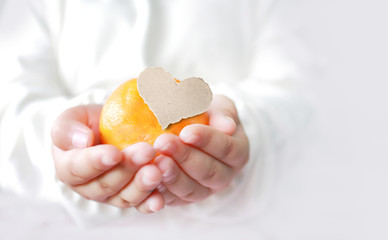 Asian young girl with orange and sheets of blank paper.Valentine's day concept background .