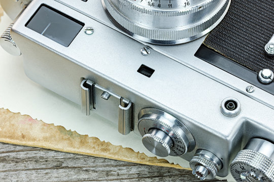vintage camera and old photos on wooden background macro view