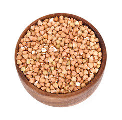 buckwheat in a wooden bowl isolated on white background