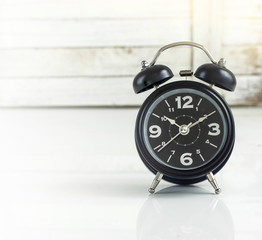 Alarm clock against wooden