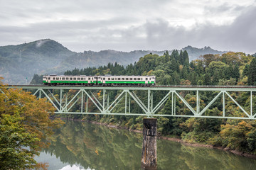 Tadami river with  bridge and train