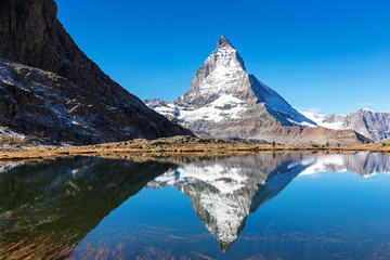 Naklejka na ściany i meble Matterhorn mountain view from Riffelsee lake on high mountain in