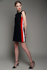 high fashion woman in short black dress.