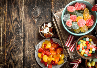 Different sweet candy, jelly, marshmallows and candied fruits.