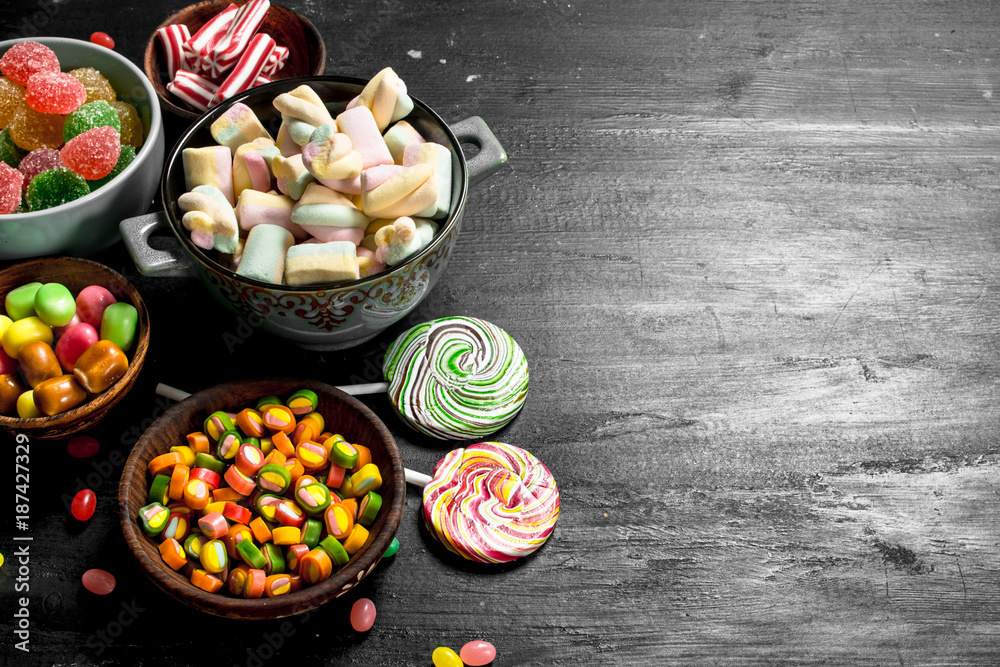 Poster Different sweet candy, jelly and candied in a bowl.