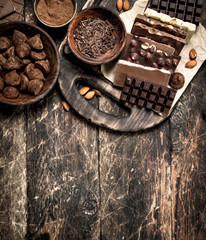 Chocolate bars with truffles and cocoa powder.