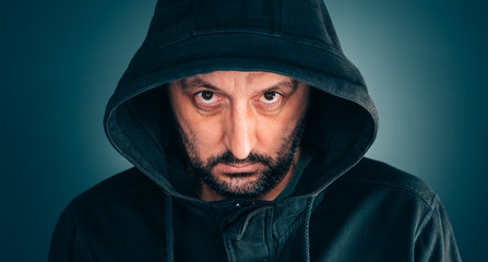 Fototapeta na wymiar Serious portrait of adult man with hoodie
