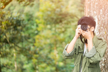 Professional photographer taking picture in the jungle.