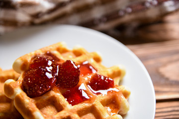 Tasty homemade waffle and strawberry jam