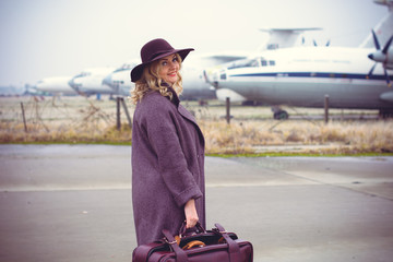 A lady in a woolen coat and a felt hat, a stylish and fashionable woman is going on the road. Stylish look on the road and at home 