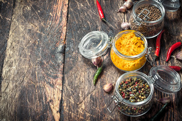 Various spices in glass jars.