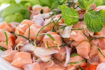 Salmon spicy salad with lemon grass isolated on white background