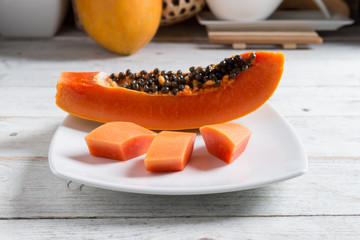 Papaya fruit on wood background.