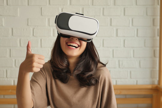 woman with vr headset giving thumb up gesture