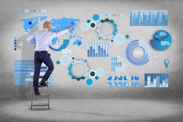 Businessman in front of a wall writing on a business graph and chart interface - business concept