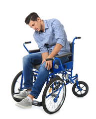 Obraz premium Attractive young man in wheelchair on white background