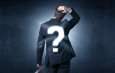 Man standing with question mark on his back