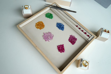 working path gem in wooden and leather plate with tool beside on white table