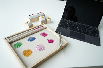 working path gem in wooden and leather plate with tool beside on white table