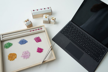 working path gem in wooden and leather plate with tool beside on white table