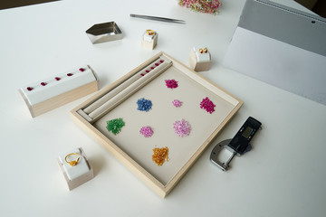 working path gem in wooden and leather plate with tool beside on white table