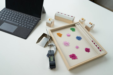 working path gem in wooden and leather plate with tool beside on white table