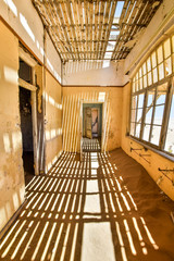 Inside view of one of the abandoned houses in the ghost town of Kolmanskop near Lüderitz in Namibia, Africa. After the diamond rush ended, the houses are slowly getting swallowed by sand and dunes.