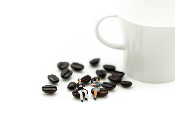 Miniatures people :  sitting on coffee bean using as background business concept.