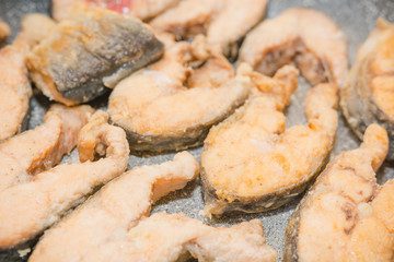 Fish to be pan fried. Slices of fried fish. Fish in flour to be pan fried.