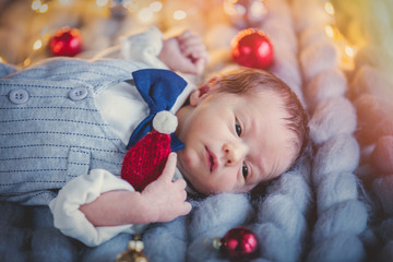 Infant in costume lying down with Christmas decoration