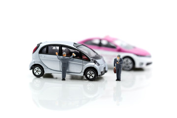 Miniature people: Worker cleaning car and businessman look a watch using as background business concept.