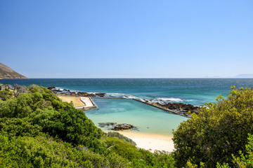 Stunning view of a big saltwater swimming pool at  Route 44 in the eastern part of False Bay near Cape Town between Gordon's Bay and Pringle Bay. Hottentots Holland Mountain range in the background.
