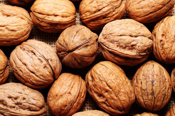 Spilled walnuts on the background of sack cloth