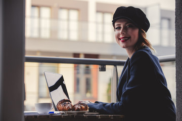 businesswoman sitting near a table in breakfast time