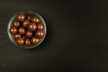Chocolate balls on the kitchen table. Unhealthy food. Risk of obesity and diabetes.