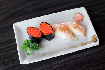 Maki sushi with flying fish roe and salmon grilled nigiri sushi.