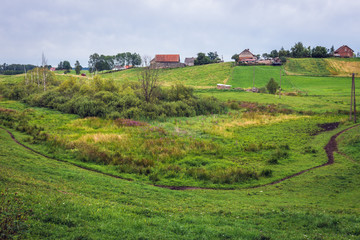 Fototapeta na wymiar Meadows and farm buildings in Masuria region of Poland