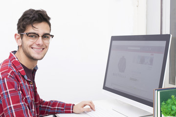 young man working on the desk with the computer