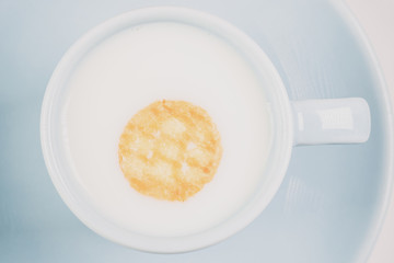 close-up of mug of milk and cookies.