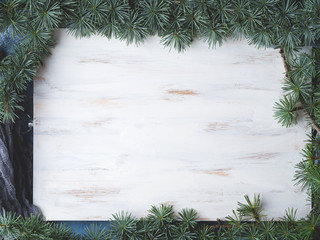 White Wooden board with branches frame background. Winter backdrop