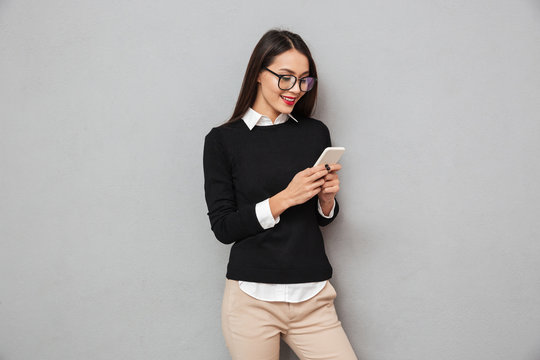 Smiling asian woman in business clothes and eyeglasses