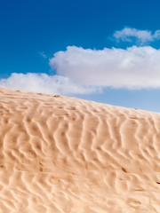Tunisian desert landscape, Douz south of Tunisia, dune and blue sky with clouds