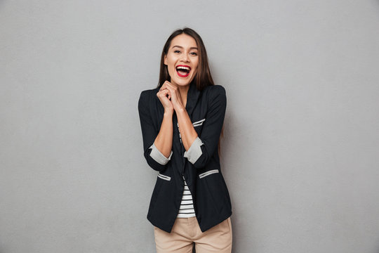 Image of Laughing asian business woman looking at the camera