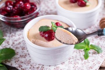 Dessert with cherry in a glass jars on wooden background