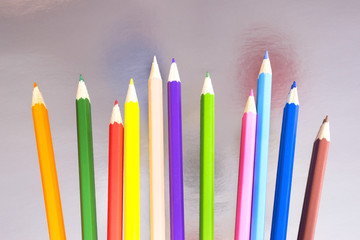 Colorful pencils on the paper background.
