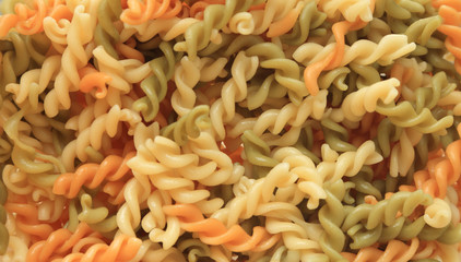 Boiled three color spiral twist pasta for use as backgrounds.