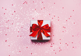 Gift box with sparkling glitter on pink background. Romantic st. Valentine's day concept of greetings. place for your text. Top view, flat lay