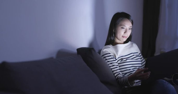 Woman use of notebook computer at night
