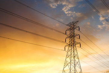 The silhouette of the evening electricity transmission pylon